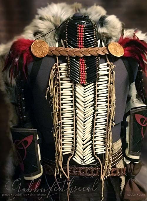 Black, white, ivory and red Beast costume with beaded chest plate and fur cloak.