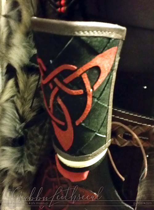 Black, ivory and brown leather bracer with red celtic knotwork for the Beast costume.