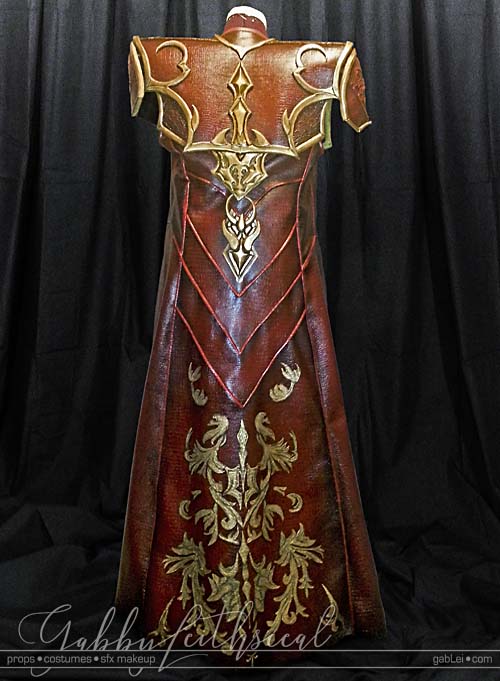 Back view of red long jacket with gold filigree details