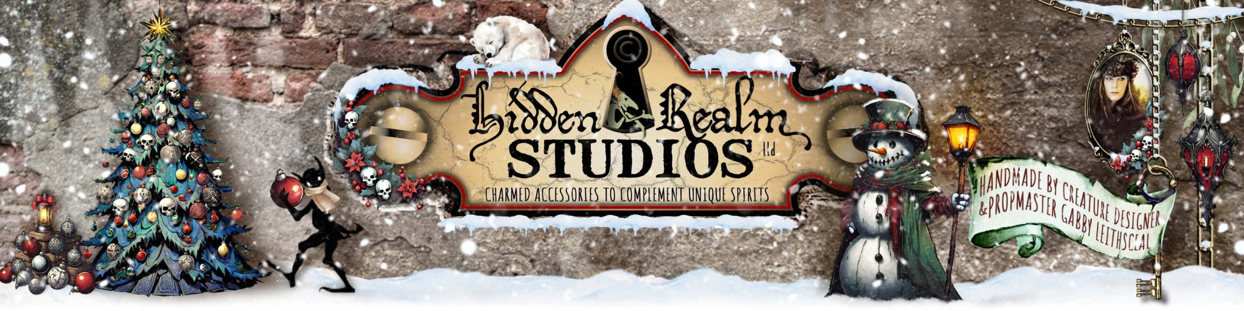 Hidden Realm Studios logo settled in a gothic, snowy xmas scene with black, red, green, and gold hues. There are skull-shaped ornaments, a snowman, glowing lanterns, and a playful goblin shadow decorating tree.